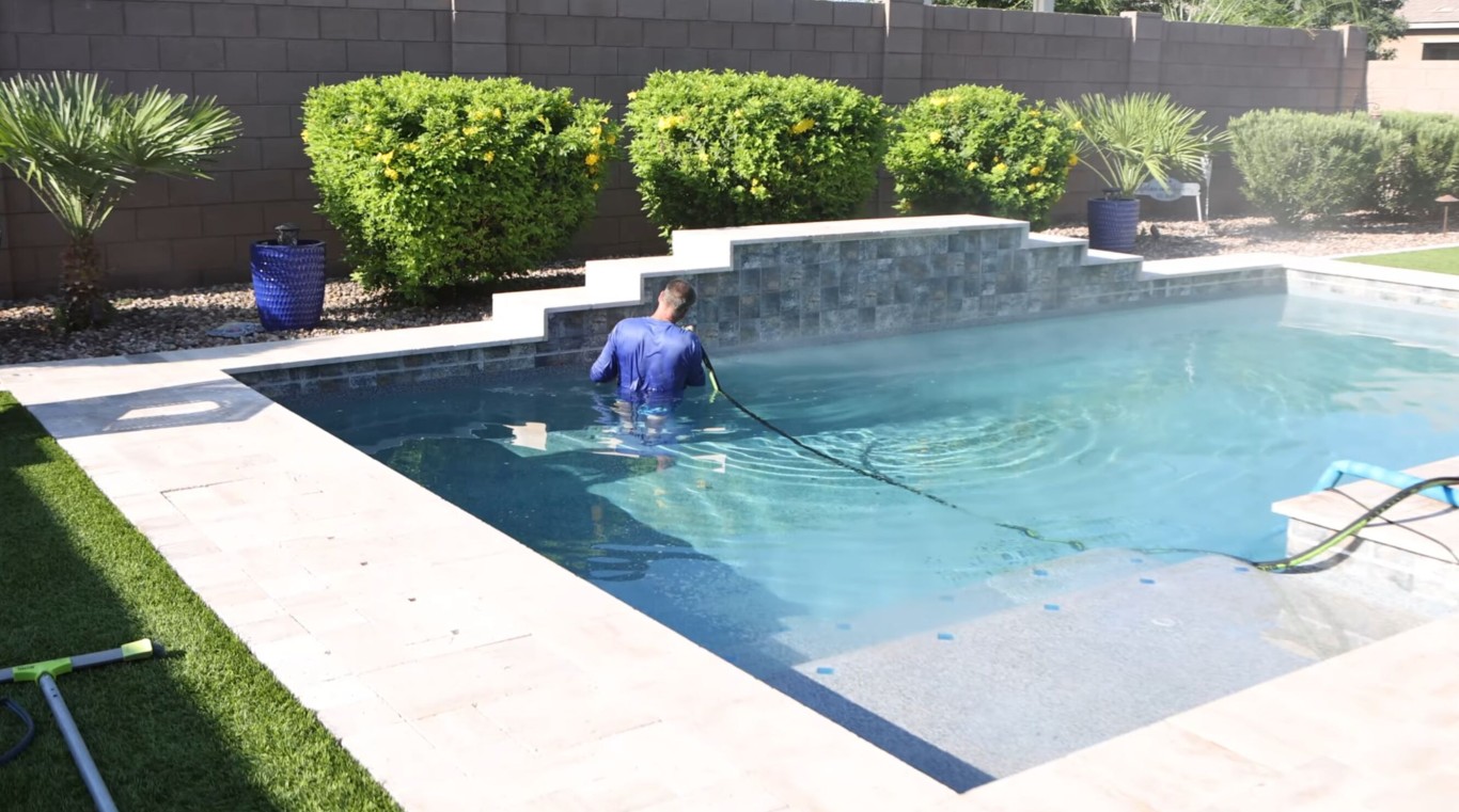 Professional pool technician performing weekly pool cleaning service in Turlock, CA